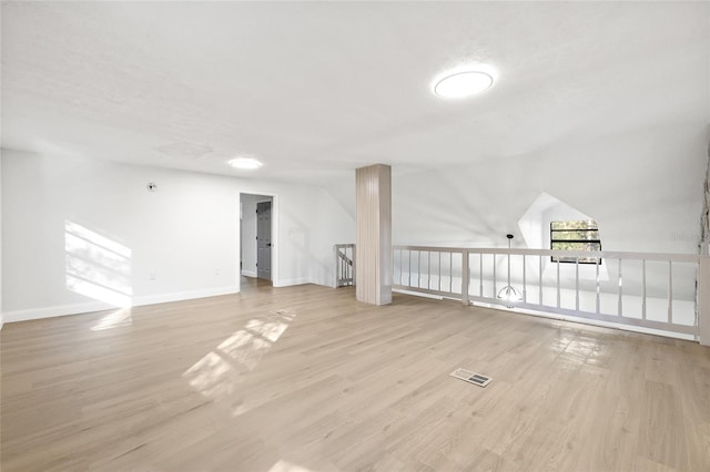 bonus room featuring light hardwood / wood-style floors and vaulted ceiling