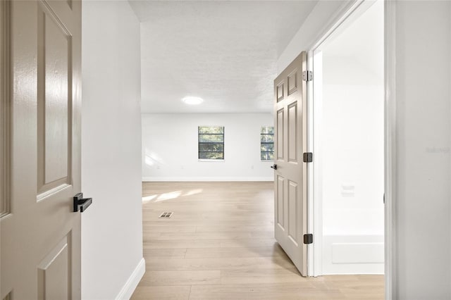 corridor featuring light hardwood / wood-style flooring