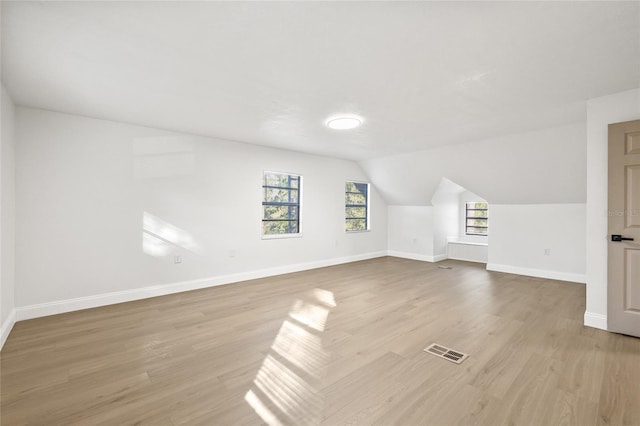 bonus room with light hardwood / wood-style flooring and lofted ceiling