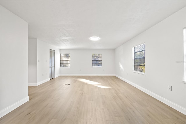 unfurnished room with light hardwood / wood-style flooring