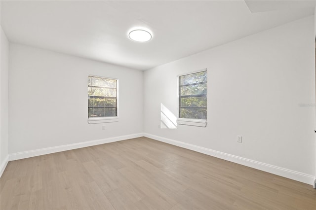 empty room with light hardwood / wood-style flooring