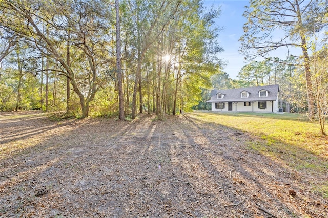 cape cod-style house with a front yard