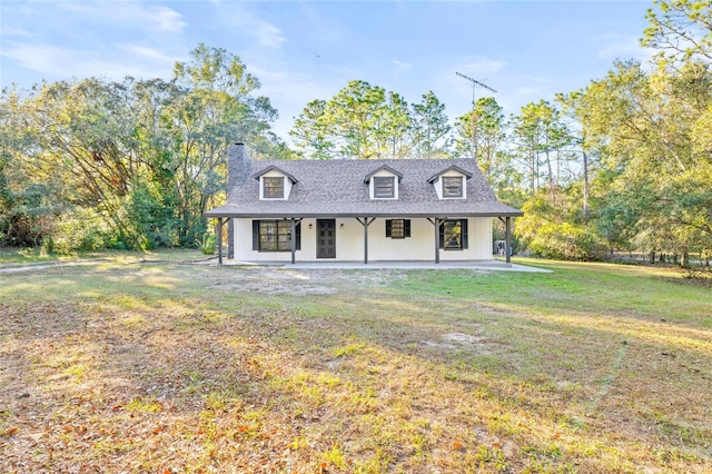 cape cod house featuring a front lawn