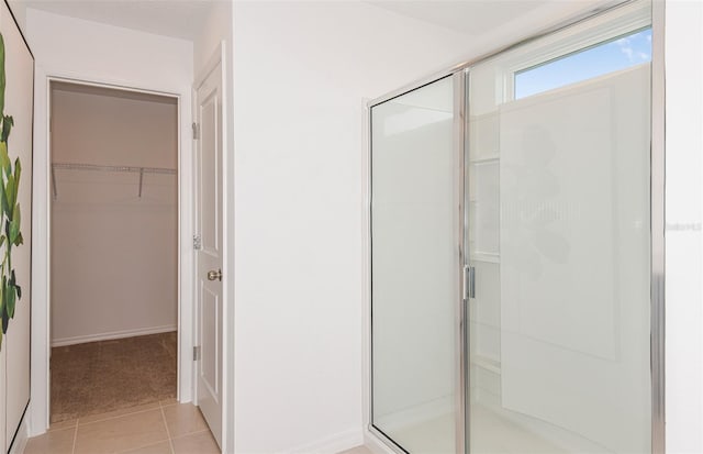 bathroom featuring tile patterned flooring and walk in shower