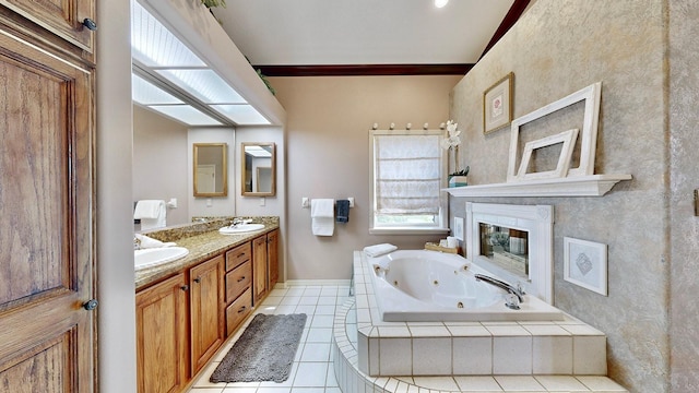 bathroom featuring tiled tub, tile patterned flooring, and vanity