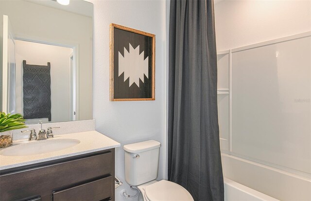 full bathroom featuring shower / tub combo with curtain, vanity, and toilet