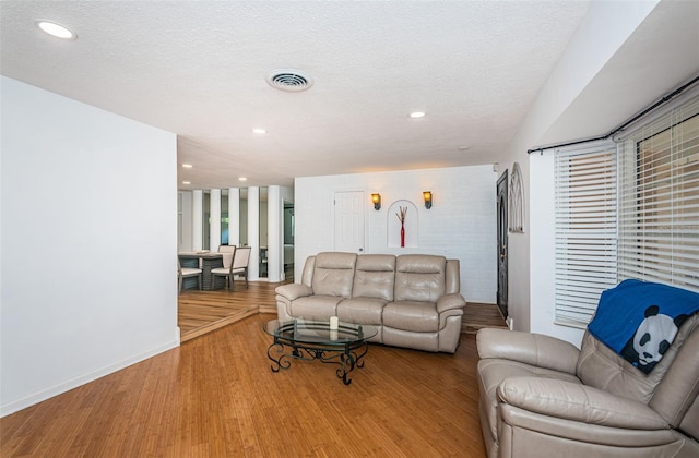 living room featuring a textured ceiling and light hardwood / wood-style flooring