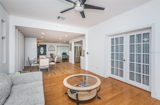 living room with french doors, light hardwood / wood-style floors, and ceiling fan