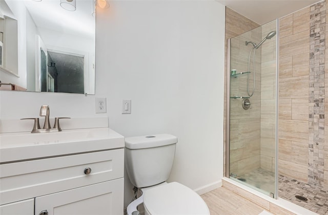 bathroom featuring an enclosed shower, vanity, toilet, and wood-type flooring