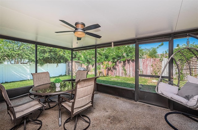 sunroom / solarium featuring ceiling fan