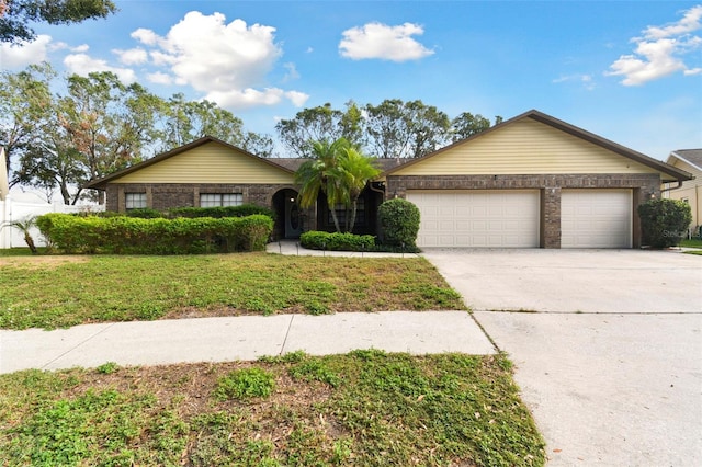 ranch-style home featuring a garage and a front lawn