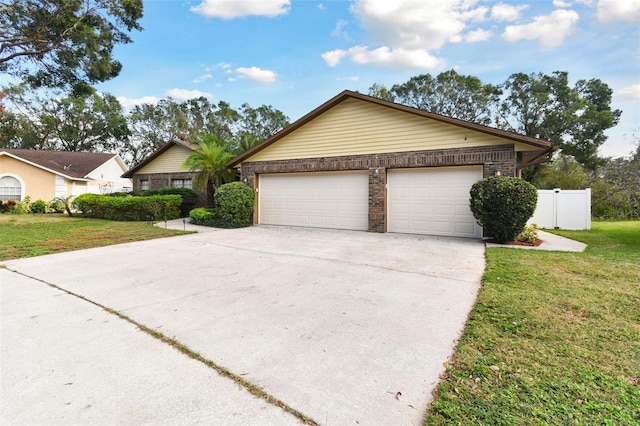 ranch-style house featuring a garage and a front yard