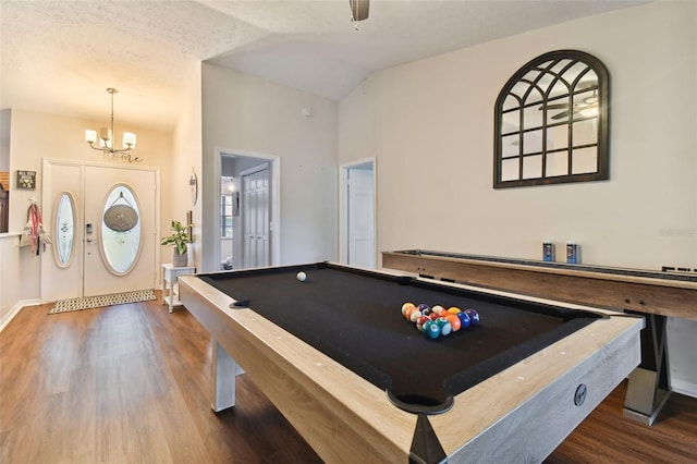 playroom featuring vaulted ceiling, an inviting chandelier, dark hardwood / wood-style floors, and pool table