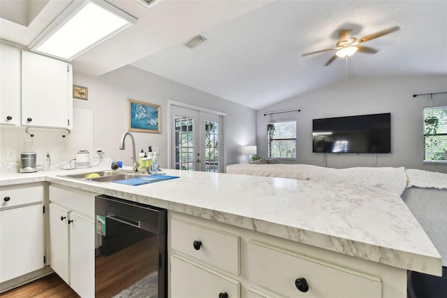 kitchen with sink, french doors, black dishwasher, dark hardwood / wood-style floors, and vaulted ceiling