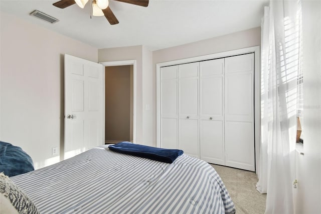 bedroom featuring light carpet, a closet, and ceiling fan