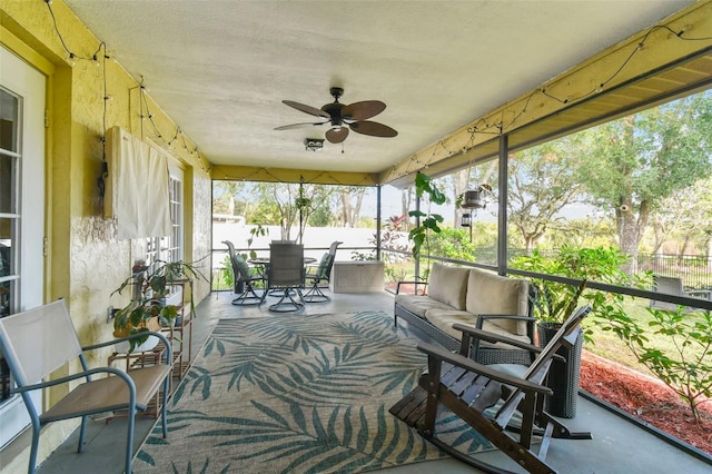 sunroom / solarium featuring ceiling fan and a healthy amount of sunlight