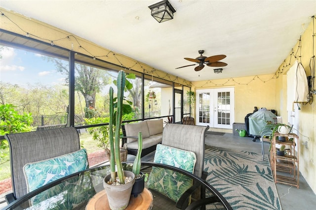 sunroom / solarium featuring ceiling fan and french doors