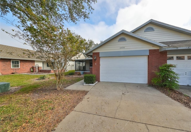 single story home featuring a garage and a front lawn