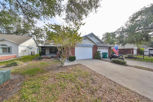 single story home with central AC unit, a garage, and a front lawn