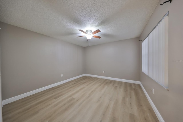 unfurnished room featuring a textured ceiling, light hardwood / wood-style flooring, and ceiling fan