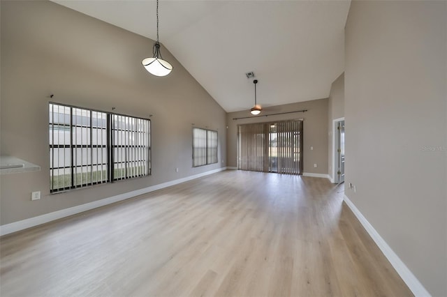 unfurnished living room featuring light hardwood / wood-style floors and high vaulted ceiling