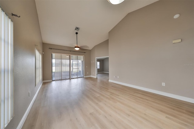 unfurnished living room with light hardwood / wood-style floors and high vaulted ceiling