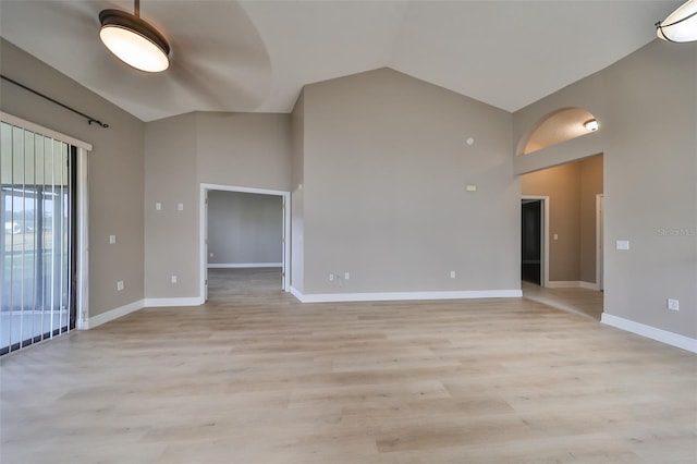 empty room featuring light hardwood / wood-style floors and high vaulted ceiling