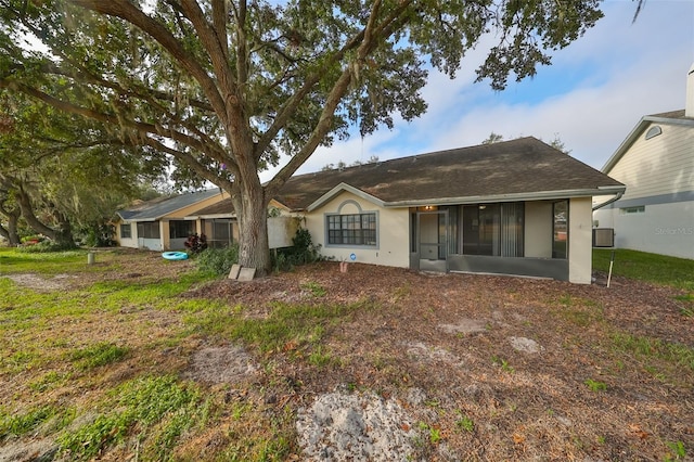 back of property with a sunroom