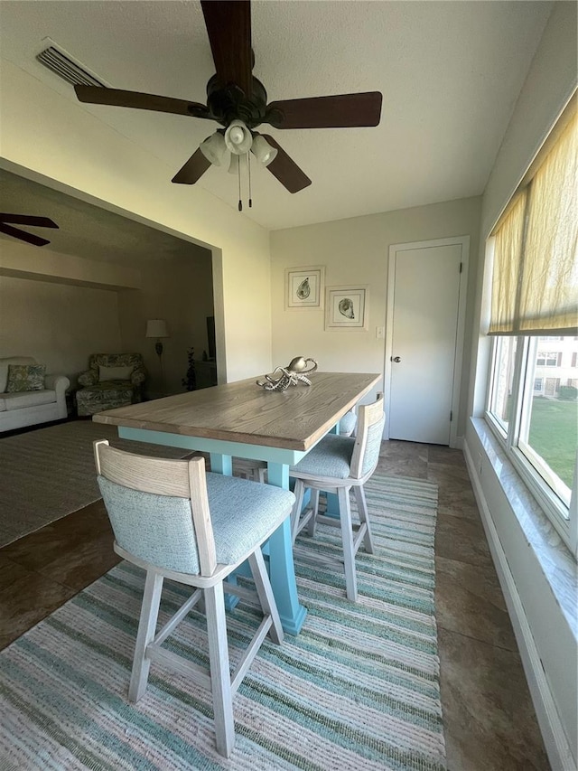 dining space with dark tile patterned flooring