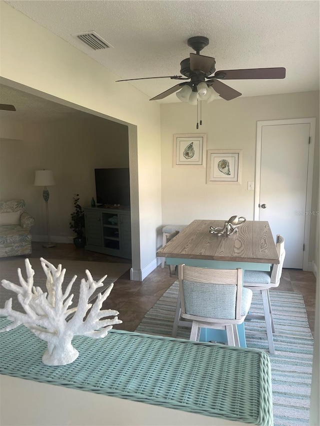 dining space featuring a textured ceiling