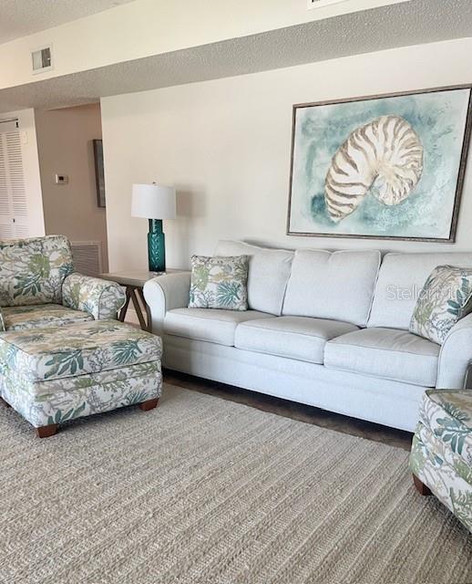 living room with a textured ceiling