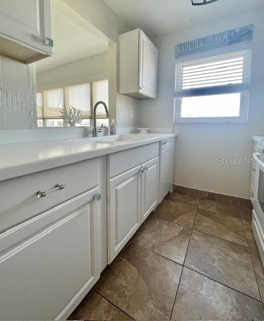 kitchen featuring white cabinetry, a wealth of natural light, and sink