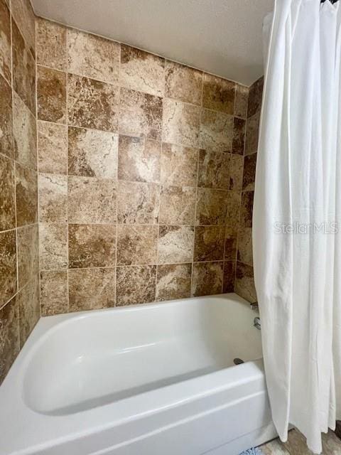 bathroom featuring shower / bath combo with shower curtain