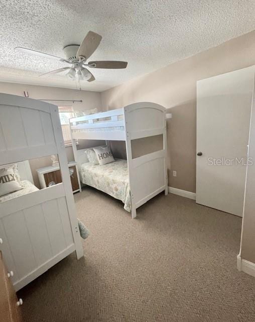 bedroom featuring carpet, a textured ceiling, and ceiling fan