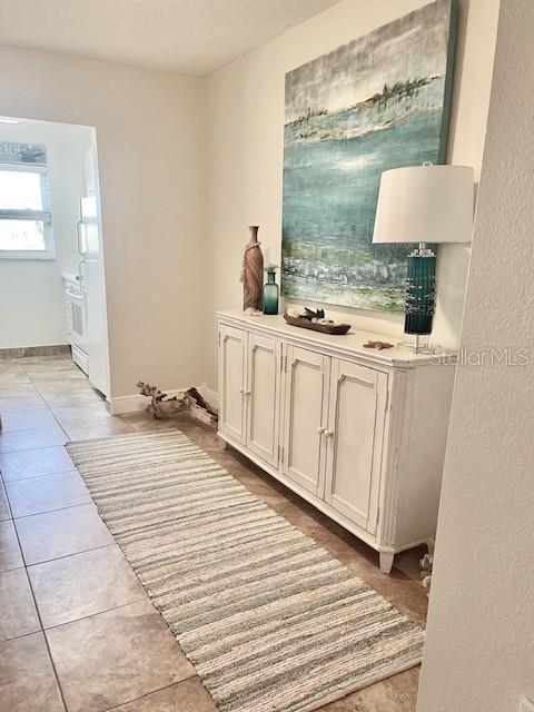 hall with light tile patterned flooring