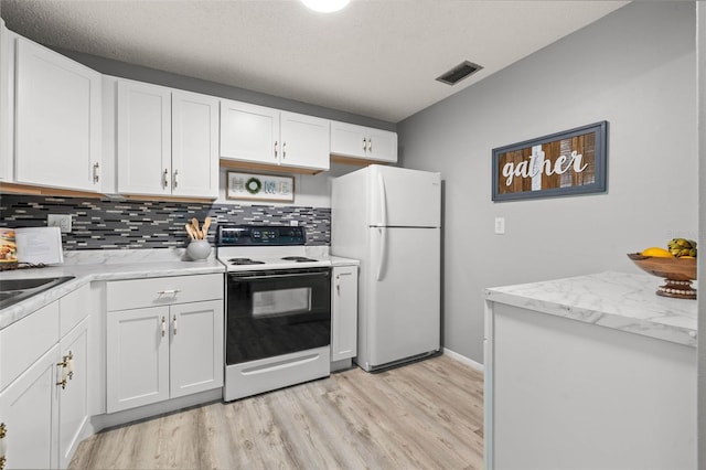 kitchen featuring decorative backsplash, light wood-type flooring, white appliances, a textured ceiling, and white cabinetry