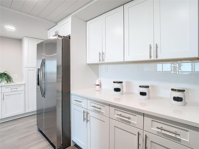 kitchen featuring white cabinetry, stainless steel fridge with ice dispenser, and light wood-type flooring