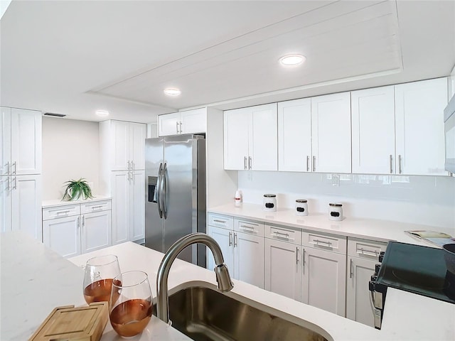 400 Island Way Unit 1411, Clearwater Beach, FL 33767 - kitchen featuring stainless steel fridge, range, light countertops, a sink, and recessed lighting