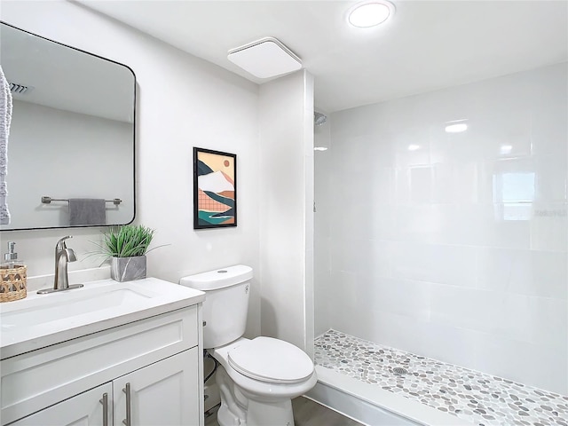 400 Island Way Unit 1411, Clearwater Beach, FL 33767 - bathroom with vanity, a tile shower, and toilet
