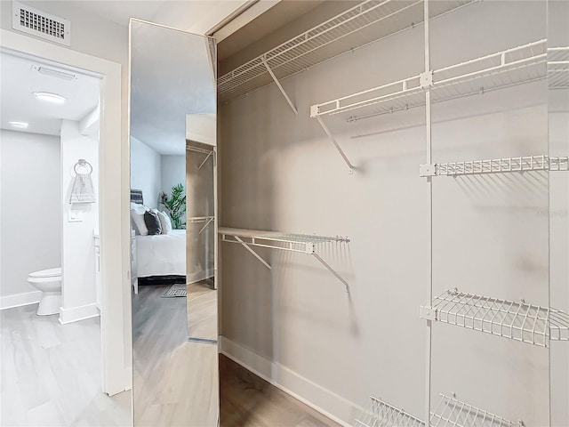 spacious closet featuring hardwood / wood-style floors