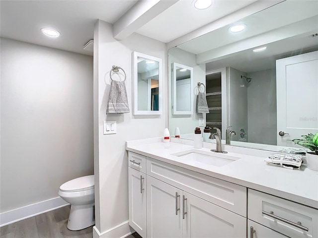 bathroom featuring hardwood / wood-style floors, vanity, and toilet