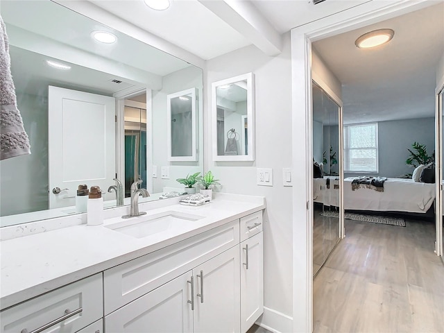 bathroom with wood-type flooring and vanity