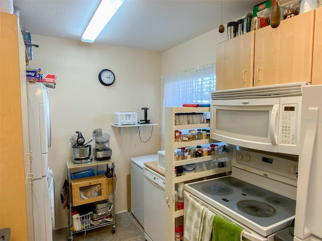 kitchen featuring white appliances and light brown cabinets