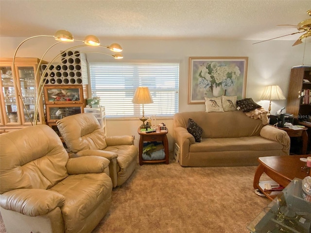 carpeted living room with a textured ceiling and ceiling fan