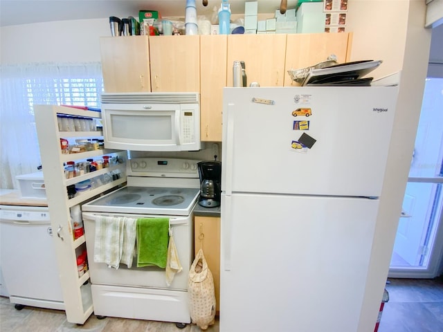 kitchen with white appliances and light brown cabinetry