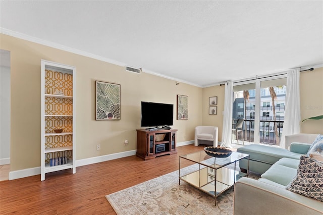 living room featuring crown molding and hardwood / wood-style floors