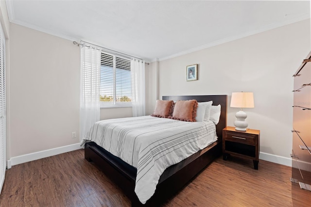 bedroom with dark hardwood / wood-style floors and crown molding