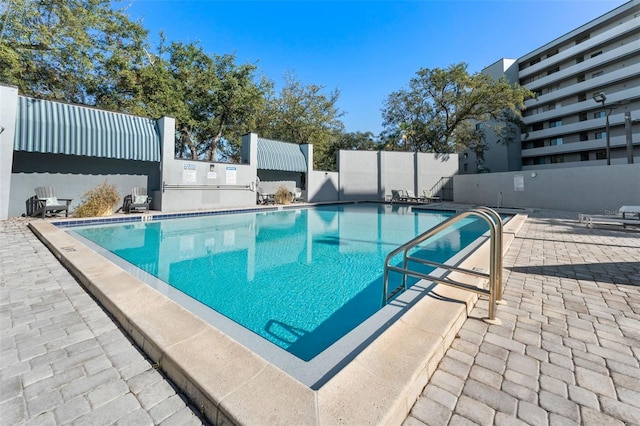 view of swimming pool featuring a patio area