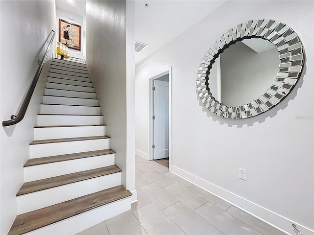 stairs with tile patterned flooring