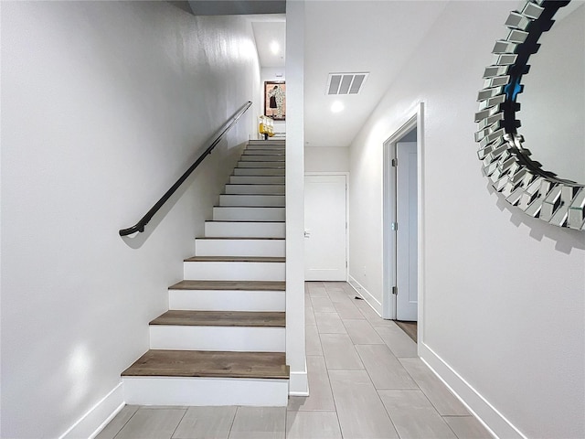 staircase featuring tile patterned flooring